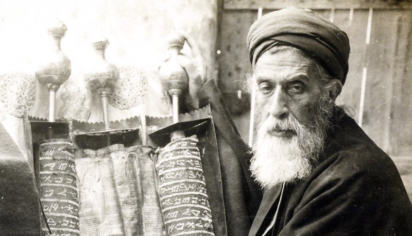 Archival photograph of a Samaritan priest beside a Torah scroll, reproduced in Abood’s manuscript